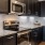 Model kitchen at our apartments for rent in Richmond, TX, featuring wood grain floor paneling and stainless steel appliances.
