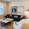 Model living room at our apartments for rent in Richmond, TX, featuring couches and wood grain floor paneling.