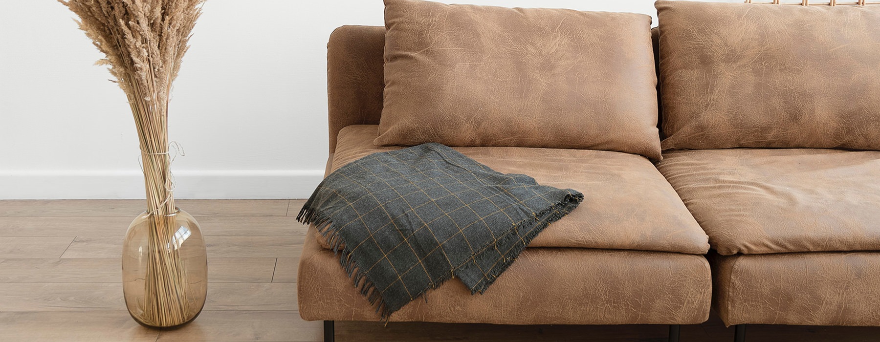 couch with vase and throw blanket